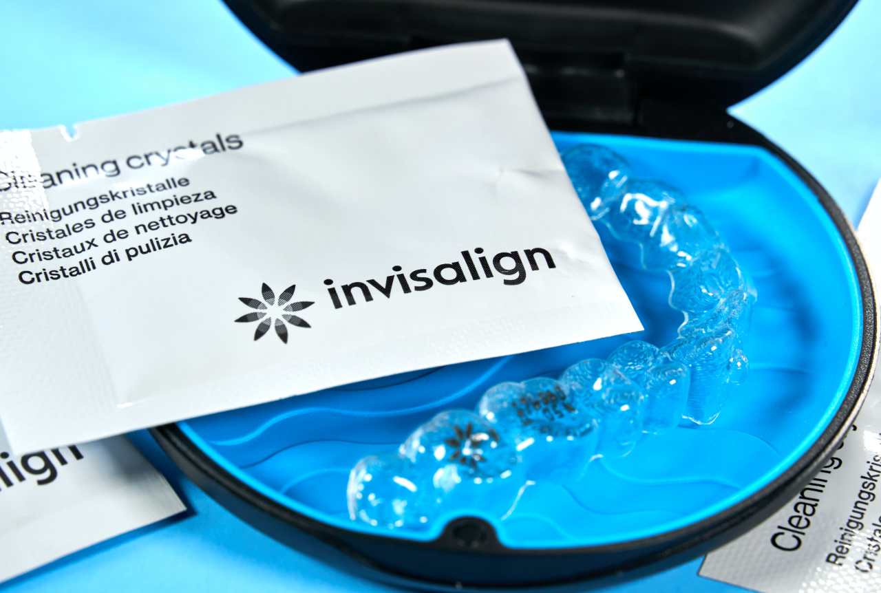 Invisalign aligners with cleaning crystals in box.